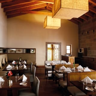 Elegant restaurant with polished wooden tables and white linen napkins